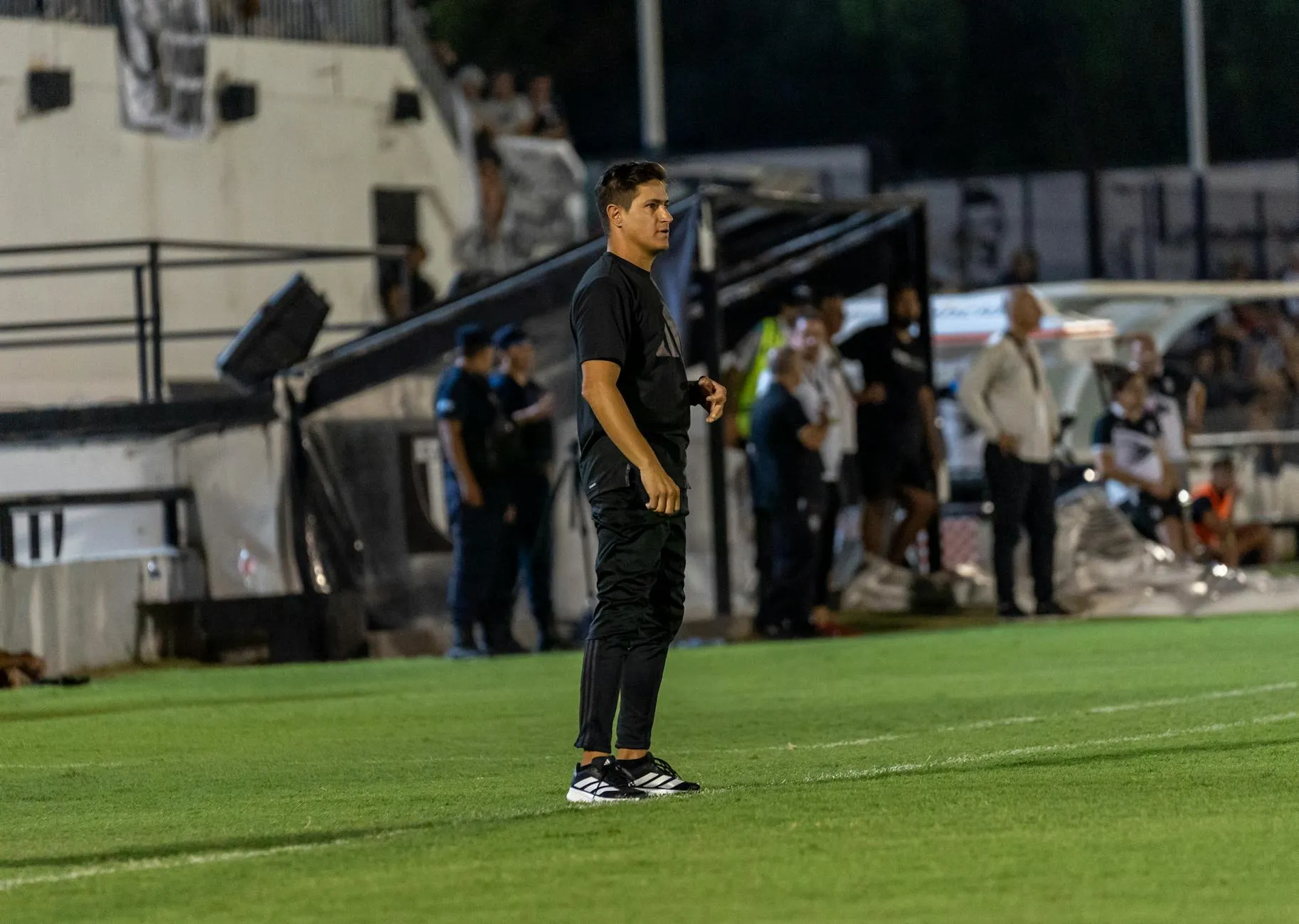 A team captain standing pitchside during a break in play, evoking the unresolved question of Luka Modric's future with the Croatia national team
