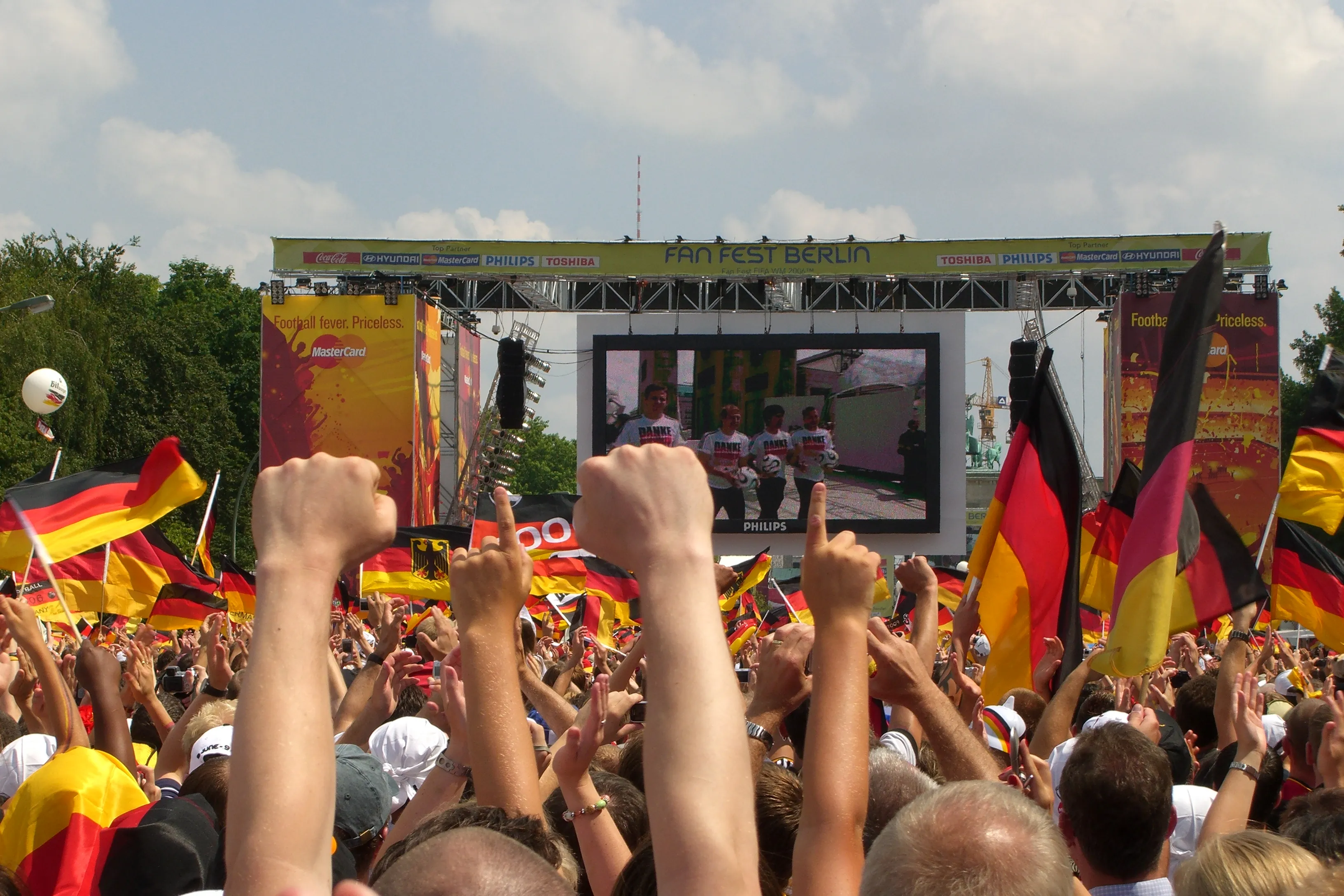 A vast crowd of Germany supporters at a fan mile — Germany topped Group E but lost their final match 2-1 to Ecuador, who reached the World Cup 2026 Round of 32 at MetLife Stadium