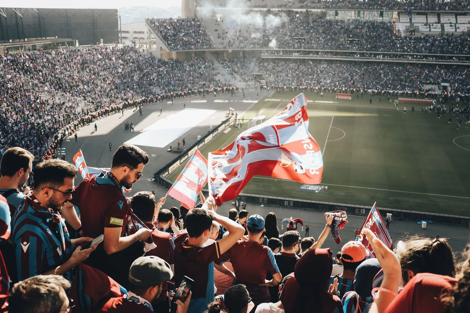 A packed World Cup crowd waving national flags — Japan drew 1-1 with Sweden in Dallas to finish second in Group F and reach the World Cup 2026 Round of 32