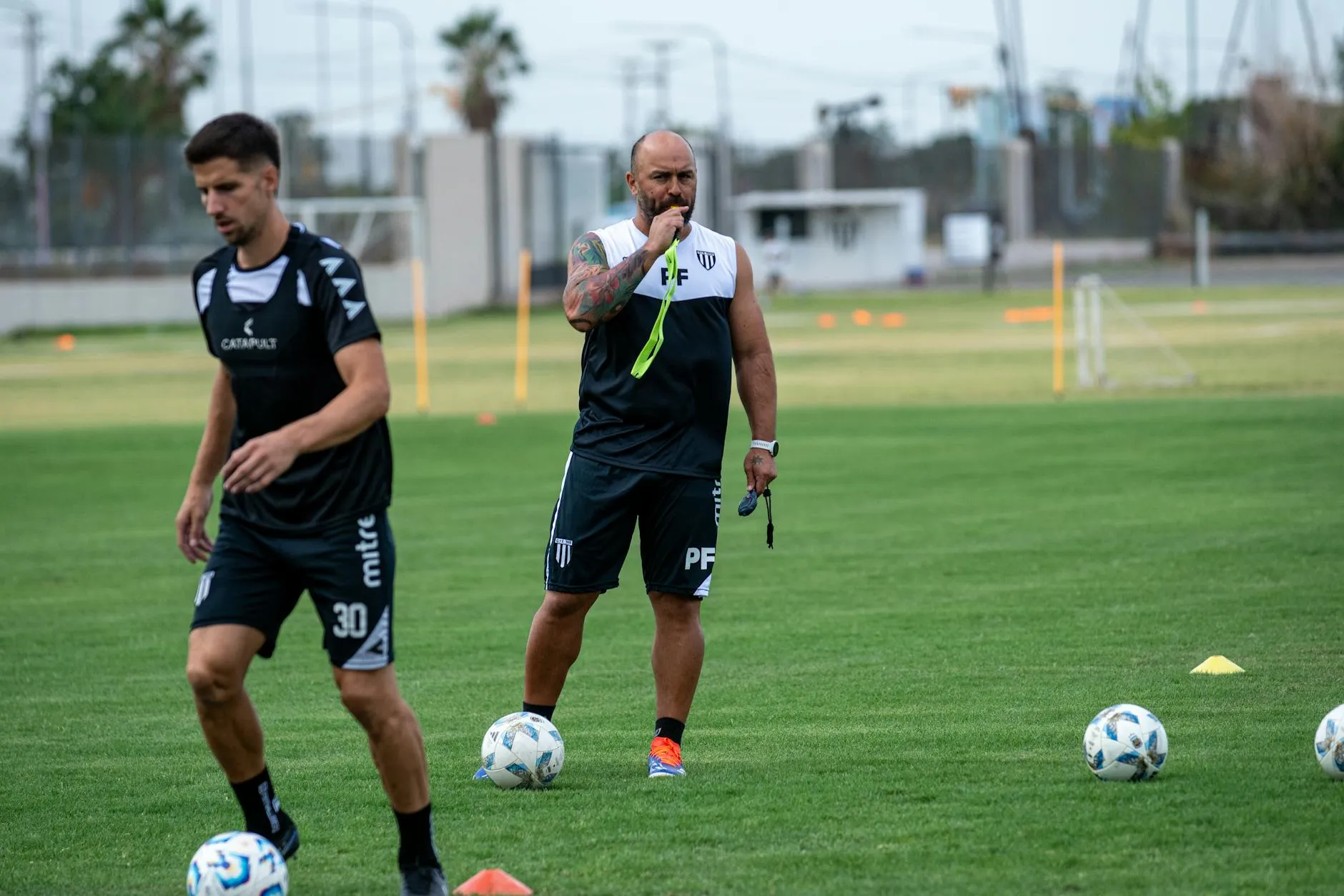 A coach instructing players on the training pitch, evoking Portugal's new head coach Jorge Jesus and his stated plans to keep working with Cristiano Ronaldo