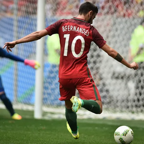 Bruno Fernandes in Portugal's dark red shirt — the Manchester United midfielder and FWA Player of the Year carries the captaincy when Cristiano Ronaldo is rested, and joins the 41-year-old captain in Roberto Martínez's 27-man preliminary squad for the 2026 World Cup, announced at the Cidade do Futebol in Oeiras on Tuesday May 19 ahead of Portugal's Group K opener vs DR Congo at NRG Stadium in Houston on Wednesday June 17